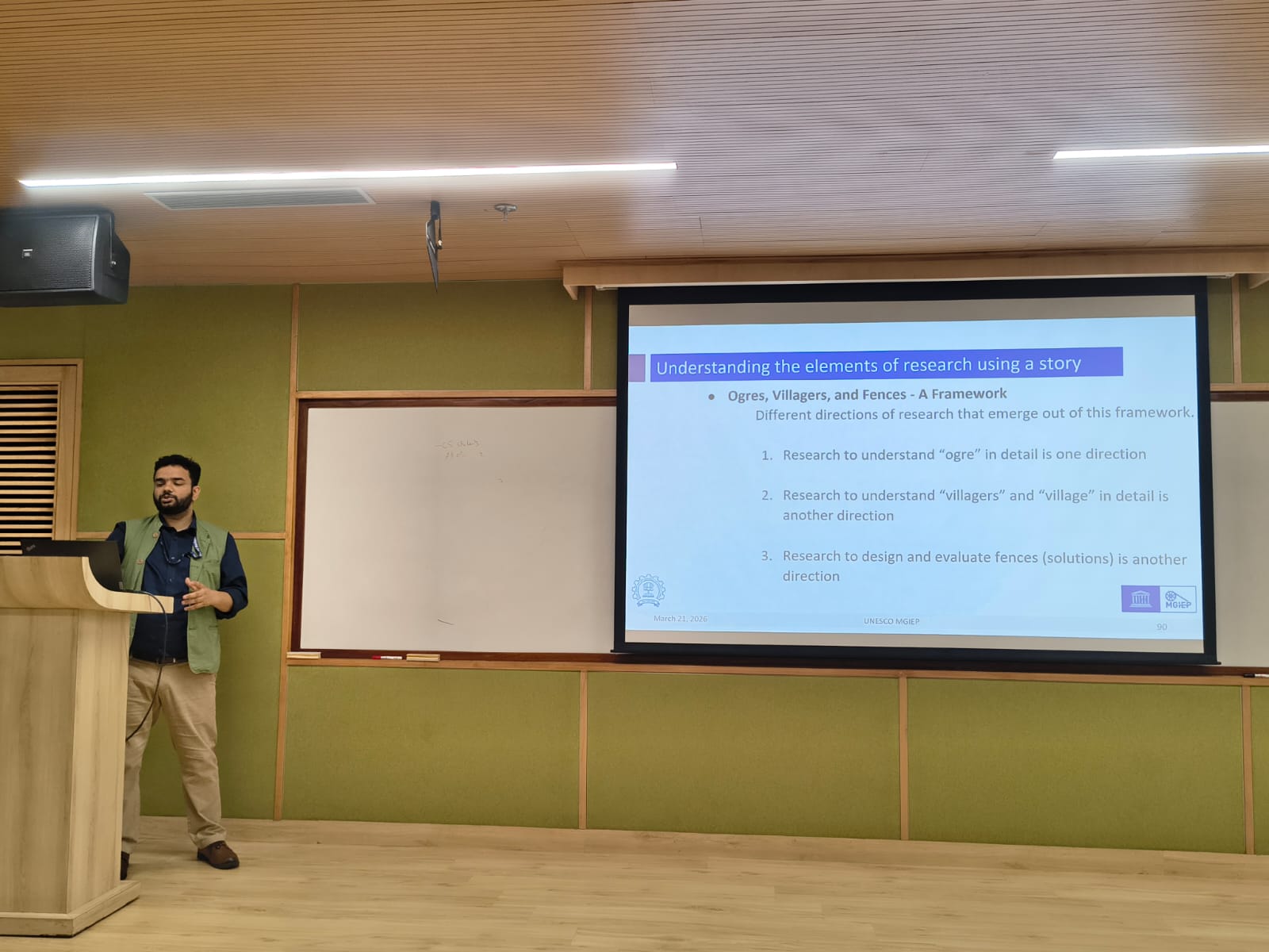 Speaker presenting on research frameworks at ACM COMPUTE 2026